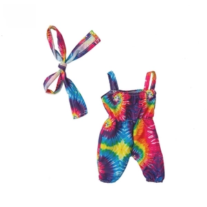 Flat lay of tie-dye baby romper and headband set with colorful vibrant patterns