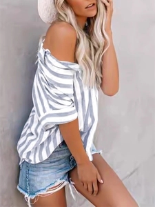 Detail showing grey and white vertical striped short sleeve shirt styled with denim shorts