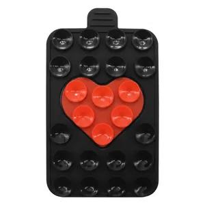 Close-up of heart-shaped silicone suction cup phone pad with dual-color non-slip design