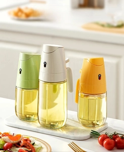 Detail of 300ml and 500ml glass oil sprayers in mint, cream and yellow colors