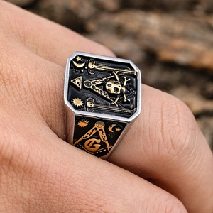 Detail of Freemason skull ring in stainless steel with gold and silver accents