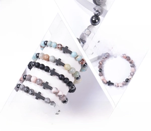 Detail of 8mm natural gemstone bracelets with a cross charm and varied mineral beads