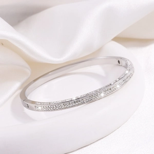 Detail shot of silver titanium steel bracelet with double rows of pavé crystals on silk