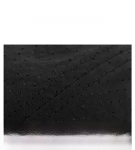 Macro detail of breathable perforated fabric with triple reinforced stitching on black cap