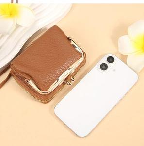 Brown lychee grain leather card holder with kiss-lock clasp and zipper detailing