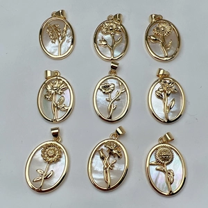 Set of 9 gold shell flower pendants featuring white mother of pearl in oval floral designs