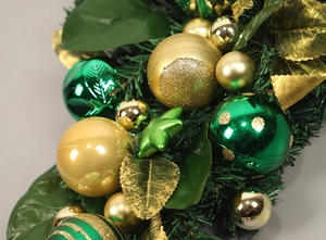 Detail of Christmas wreath with gold and green ornaments, stars and pine needles