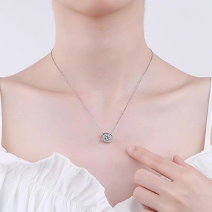 Close-up of a 2-carat zircon pendant necklace with small diamonds on model neck