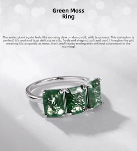 Macro view of three rectangular green moss agate stones set in a polished silver band