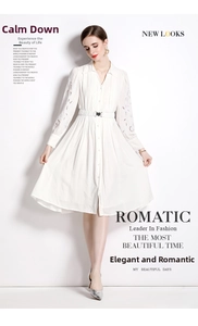 Détail d'une robe midi blanche avec broderie anglaise sur les manches et col chemise boutonné
