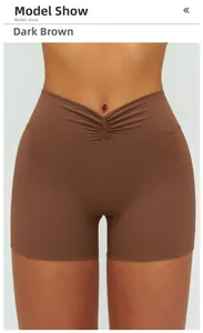Detail of dark brown high waist yoga shorts featuring a V-shaped crossover pleated waistband