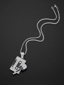 Macro shot of silver hip-hop cassette and microphone pendant with crystals