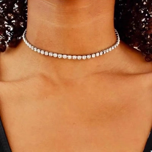 Elegant silver-tone tennis choker necklace with sparkling round-cut clear crystals on model