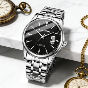 Detail view of silver stainless steel watch with black dial and calendar display