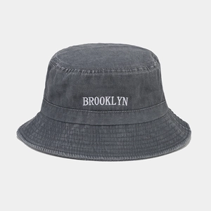 Détail de la broderie Brooklyn sur un chapeau bob en denim gris foncé délavé avec coutures