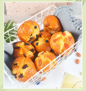 Detailed view of 7 assorted realistic PU muffin models in a white metal basket decoration