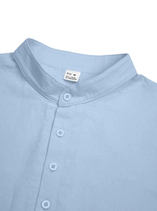 Detailed close-up of light blue linen shirt collar showing texture and label information