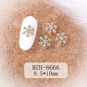 Detail of silver snowflake nail charms with rhinestones measuring 8.5x10mm for DIY manicure