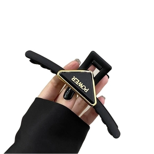 Matte black acrylic triangle hair claw clip with POWER lettering for elegant updos