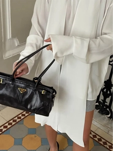 Classic black textured leather handbag with metal logo and sleek shoulder strap style