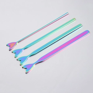 Detail of four stainless steel mermaid tail stirrers with rainbow plating finish
