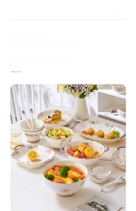 Detailed view of floral ceramic bowls and plates set with salad and fresh food