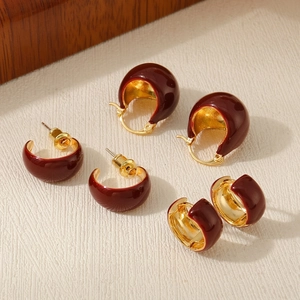 Three pairs of vintage burgundy red enamel and gold-plated earrings in a stylish set