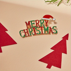 Golden Merry Christmas enamel brooch with red santa hat and festive green accents