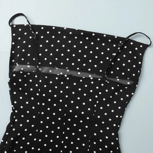 Detailed view of polka dot dress featuring thin straps and seamless back zipper design