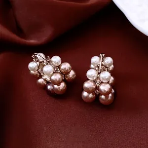 French vintage cluster pearl earrings with gold plating on deep red silk fabric