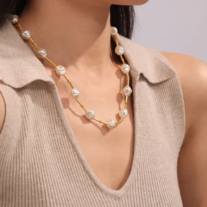 Baroque pearl and 18k gold plated titanium steel choker necklace on female model