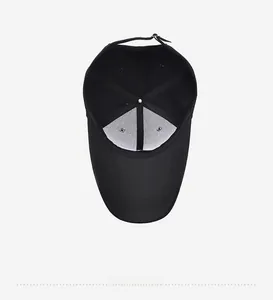 Internal detail of a black cotton baseball cap showing 6-panel structure and seams