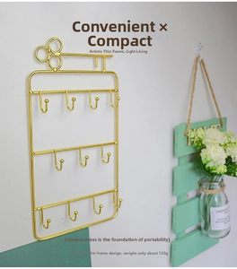 Golden key-shaped jewelry organizer with 11 hooks for earrings and necklaces