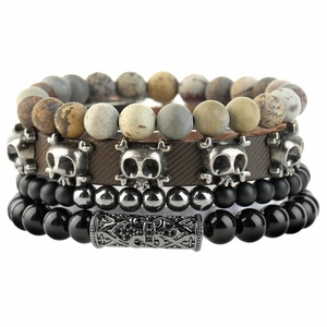 Detail of four-piece layered bracelet set with tiger eye, skull leather, and metal beads