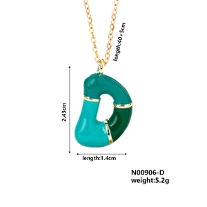 Detail showing dimensions of green enamel letter D pendant necklace on a gold chain