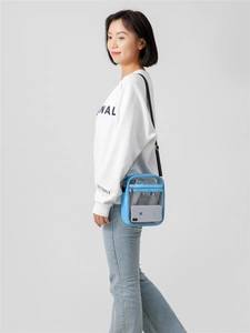 Model wearing a blue transparent PVC crossbody bag showing clear waterproof jelly material