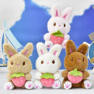 A collection of cute plush bunny rabbit pendants holding strawberries in four colors