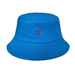 Detailed view of red heart embroidery on blue cotton bucket hat with stitching
