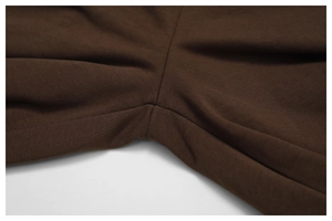 Macro shot of precise stitching and soft coffee brown fabric on women's sports pants