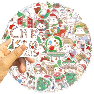 Detail of Christmas ghost stickers showing size held by hand with festive patterns