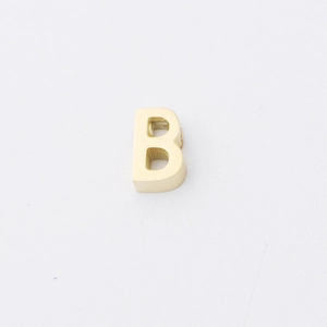 Macro shot of 1.8mm hole capital letter B bead in matte golden stainless steel