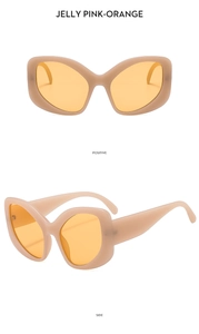 Macro view of jelly pink-orange cat eye sunglasses frame with semi-transparent texture