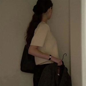 Detail showing the retro off-white knitted short sleeve top on a model from a side view
