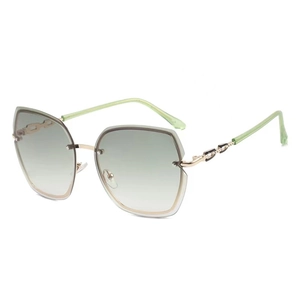 Frameless oversized sunglasses with green gradient lenses and gold chain metal temples