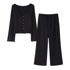 Women's two-piece black pleated outfit featuring V-neck cardigan and wide-leg trousers