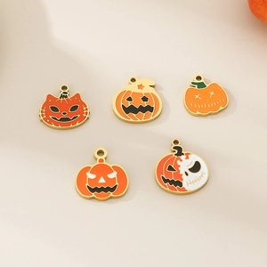 Set of five Halloween pumpkin and cat enamel charms with gold edges on beige background