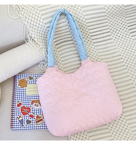 Close-up of heart-shaped quilting and pink-blue contrast on a canvas tote bag