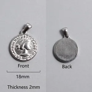 Detail of silver Roman coin pendant showing Elizabeth II relief and smooth reverse side