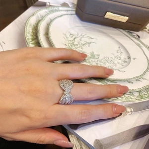 Elegant bow-shaped ring with micro-paved cubic zirconia in layered silver finish