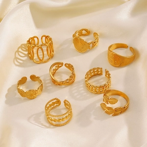 Set of 8 gold stainless steel adjustable rings featuring leaf and coin motifs on silk
